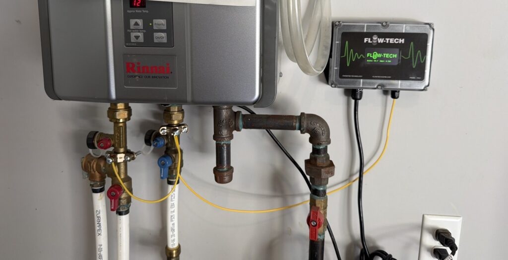 FlowTech MAX salt-free water conditioner installed beside a Rinnai tankless water heater