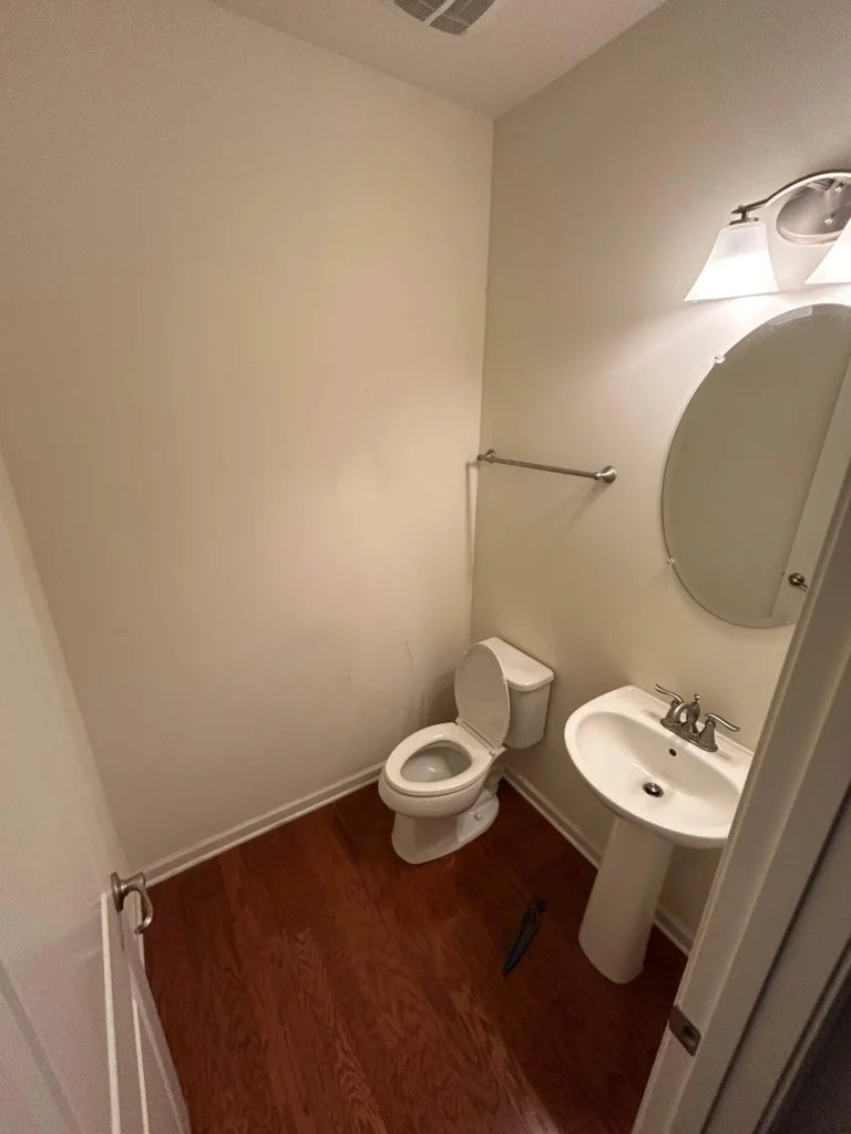 Finished bathroom with new toilet and vanity in a Brentwood half bath conversion