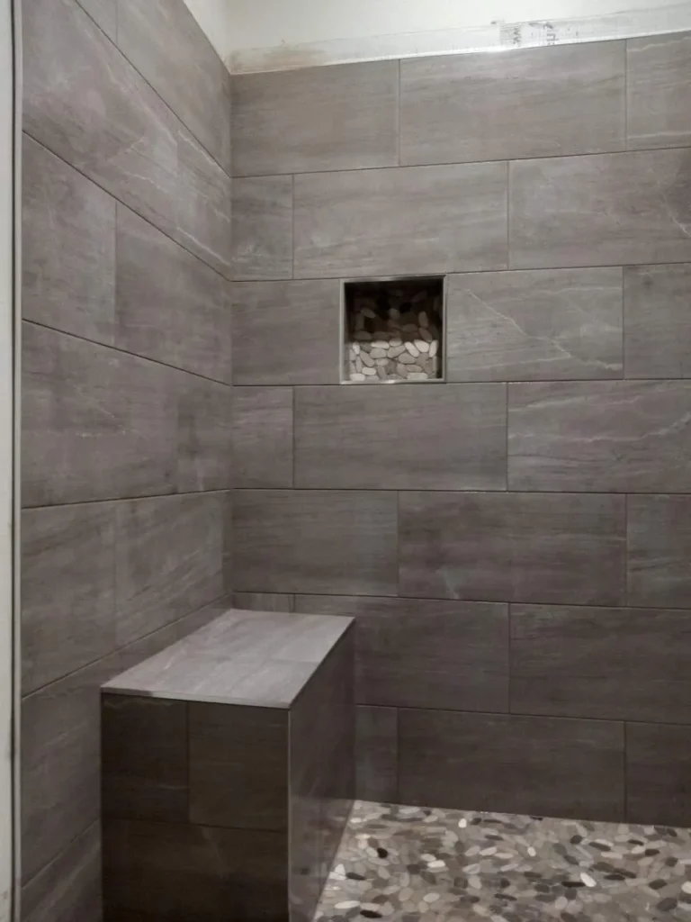 Finished tiled shower with a built-in bench in Brentwood