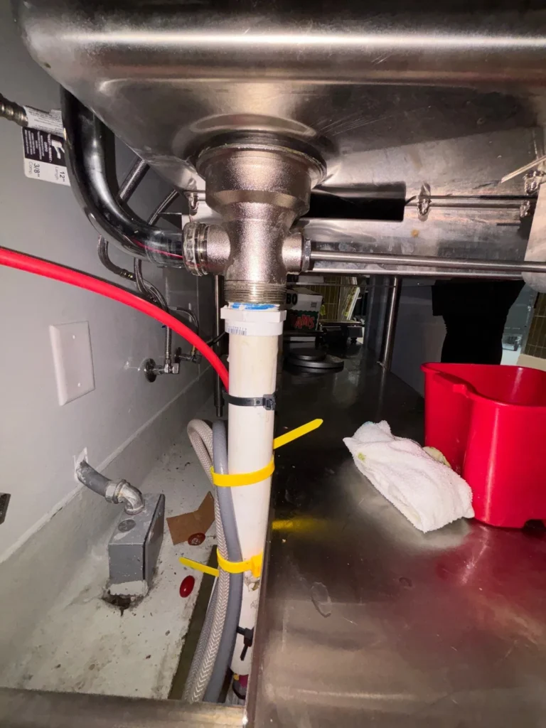 New drain fittings under a commercial prep sink in SoBro