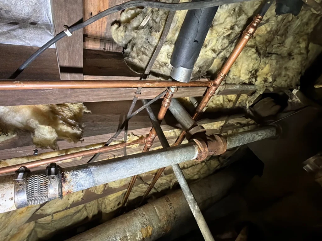New copper water lines run alongside the original galvanized steel in a Nashville crawlspace during a whole-house repipe