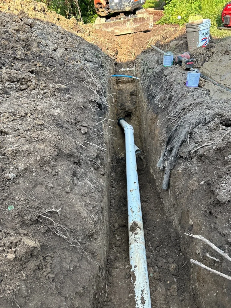 Open trench with new sewer pipe laid on a replacement in Nashville