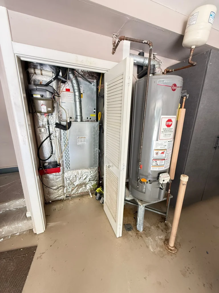 Navien tankless water heater replacing a tank unit in a Nashville garage, with re-routed gas line and new vent