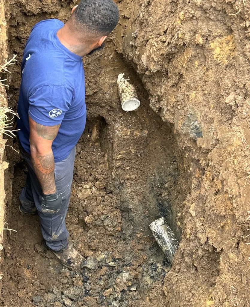 Excavating to reach a failed drain line section in Forest Hills
