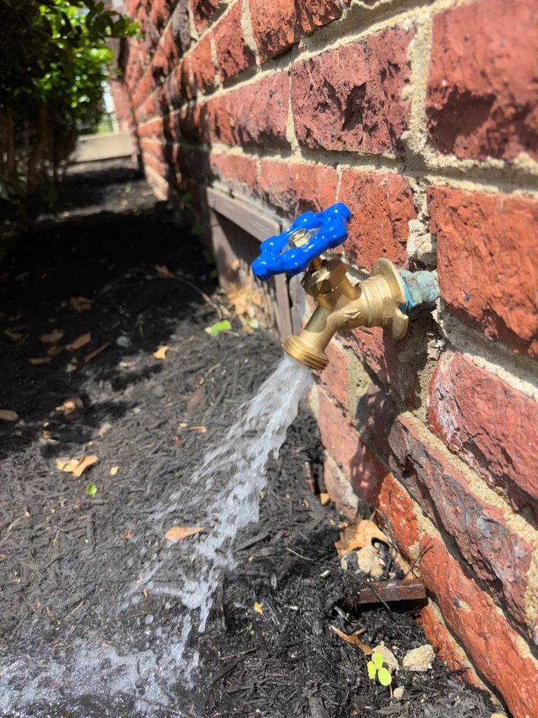 Failed hose bibb spraying at the wall before repair in East Nashville