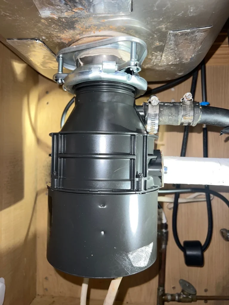 New garbage disposal fitted under a Hermitage kitchen sink